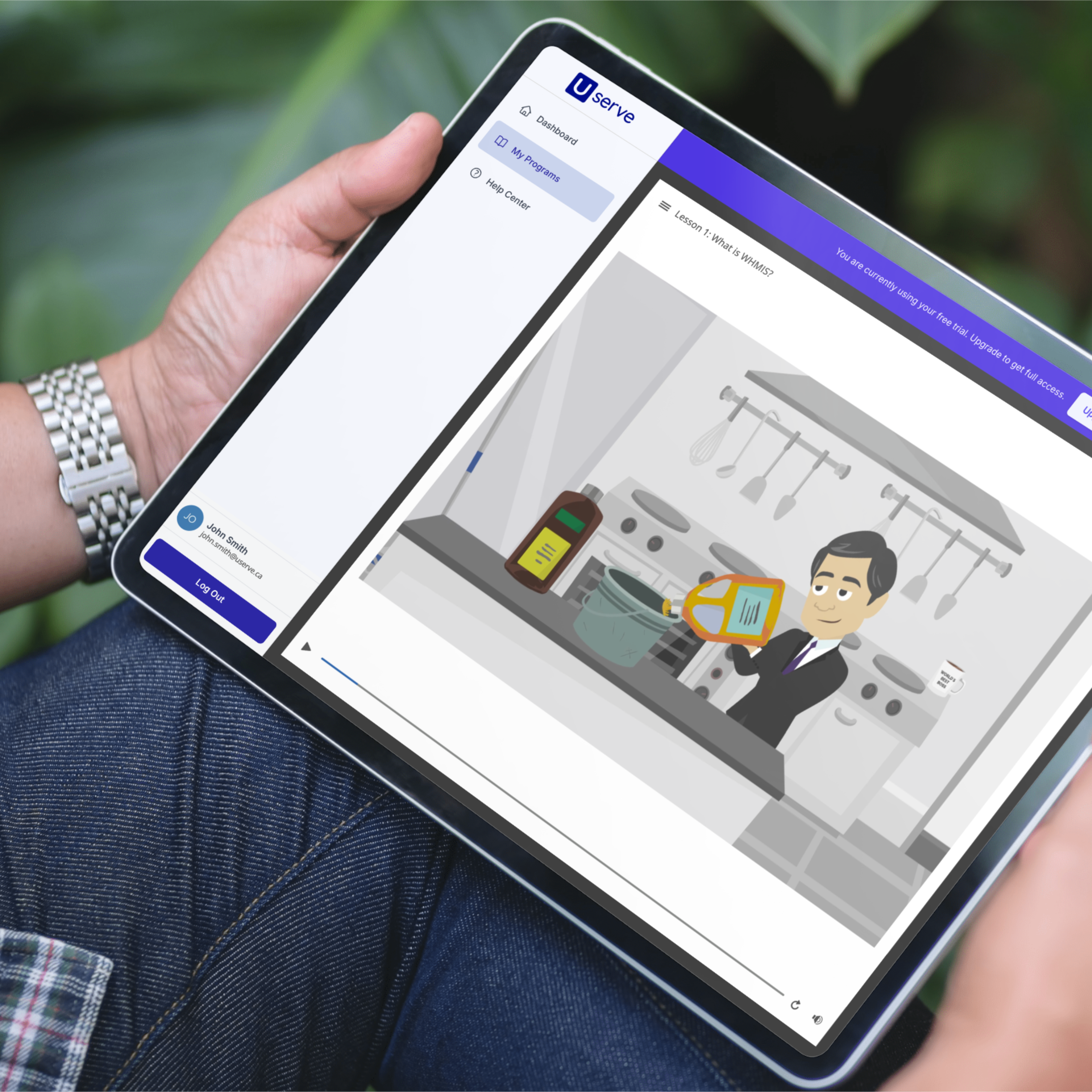 Person holding a tablet with an app open on the screen, showing a course lesson in progress.