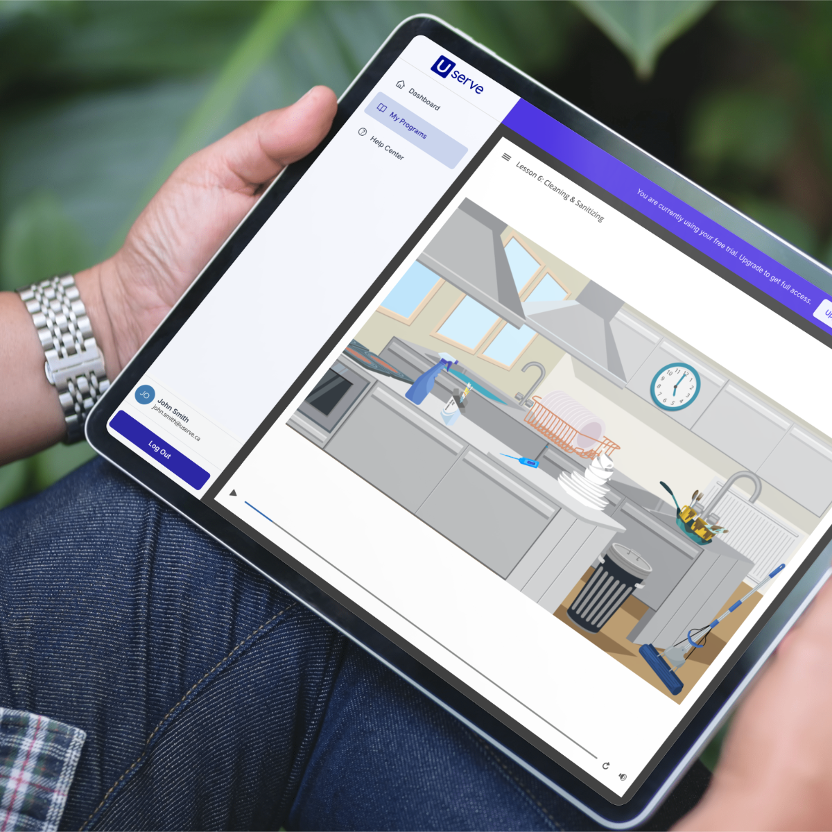 Person holding a tablet with a course lesson open.